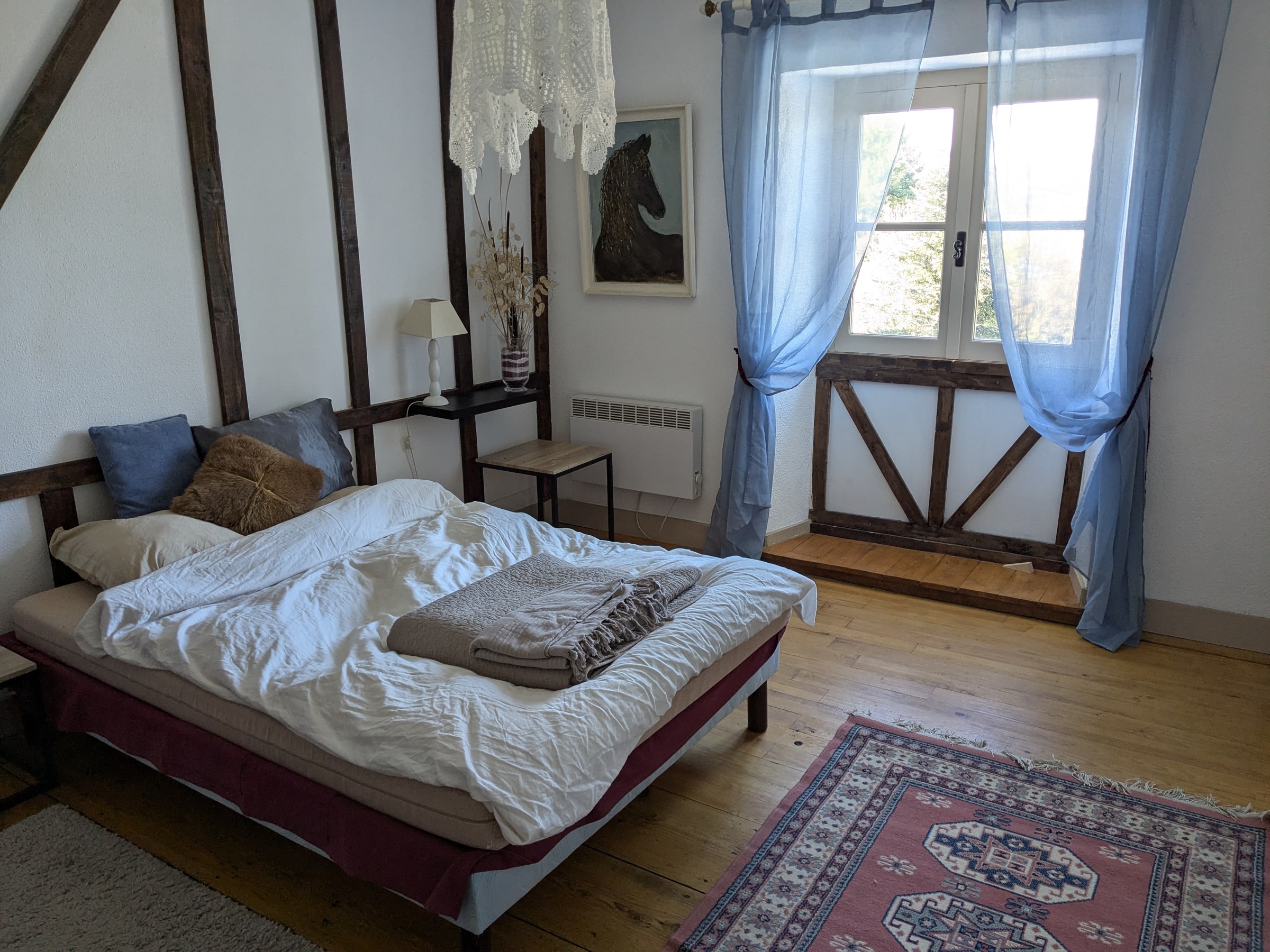A timber-framed bedroom with morning light