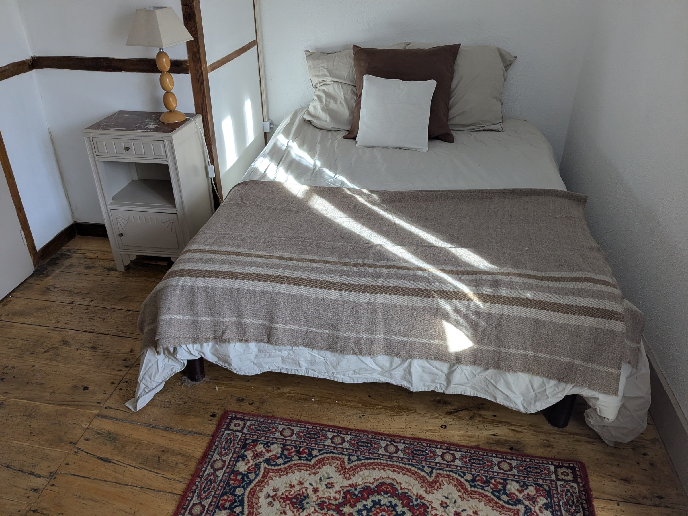 A double bedroom with old wooden floors