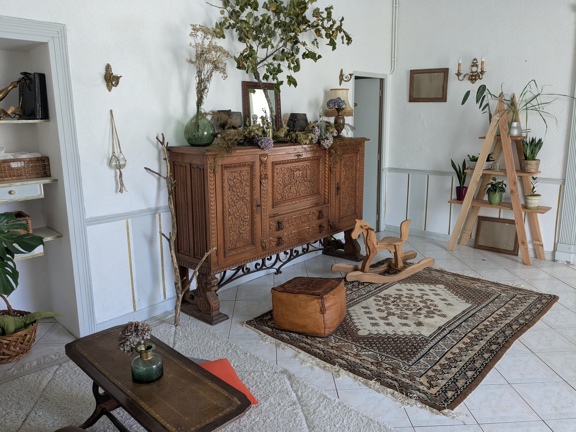 A lounge with a carved sideboard and rugs